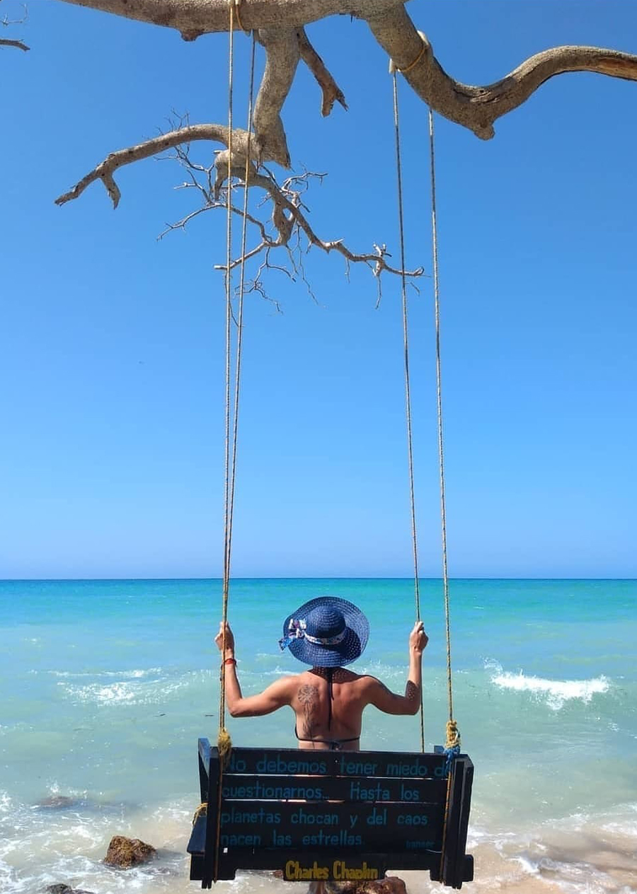 Woman on a bench swing in the islands